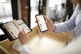 Team di un ristorante che usa Carbonara su telefono e tablet
